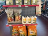 many bags of food on the shelf in the store