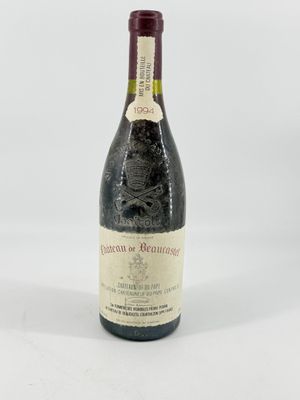 a close up of a bottle of wine on a white surface