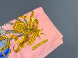 a pink and gold flag with a coat of arms on it