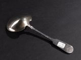 a spoon that is sitting on a black surface