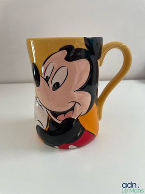 mickey mouse coffee mug with a goofy face on it