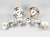 a group of cups and saucers sitting on a table