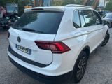 the rear of a white volkswagen suv parked in a parking lot