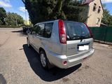 a small silver car parked in a parking lot