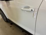 a white car that has a sticker on the side of it