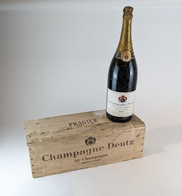 une bouteille de champagne posée sur un coffret en bois