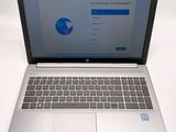 a laptop computer that is open on a white table