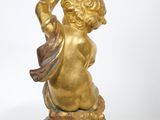 a gold statue of a child holding a basket