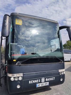 a black bus that is parked in a parking lot