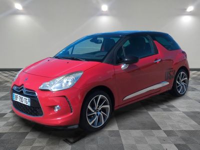 a red citrole is parked in a room with a checkered floor