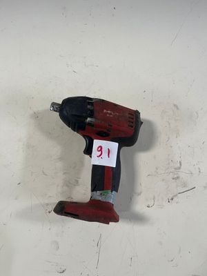 une perceuse accrochée au mur, sur laquelle figure un numéro