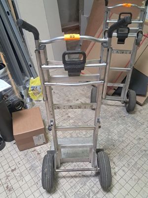 a silver hand truck with a yellow handle on it