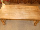 a wooden table that is sitting in the middle of a room