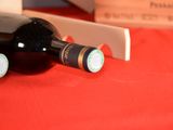 a bottle of wine sitting on a table next to a knife
