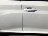 a white car that has a broken door handle on the side of it