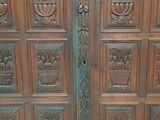 a large wooden door with carvings on it