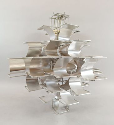 an image of a metal sculpture of a sailboat on a white surface