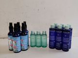 some bottles of different types of skin care are lined up on a table