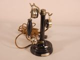 two telephones on a table with a rope around them