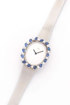 an image of a close up of a watch on a white surface