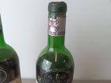 two bottles of wine that are sitting on a table