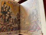 an open book with a picture of a castle on it