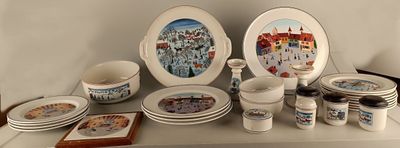 many plates and cups on a shelf with pictures on them