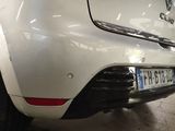 the rear end of a white car with a number plate on it