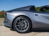 a silver sports car parked on the side of the road