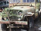 an old truck that is sitting in the dirt