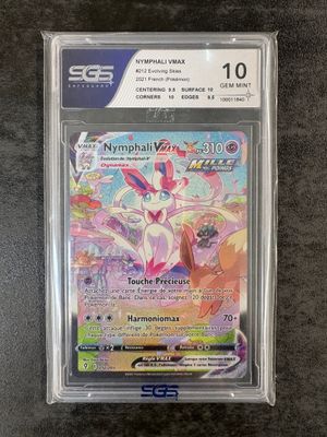 a pokemon card in a plastic case on a table