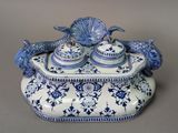 a blue and white dish with a fish on it
