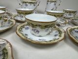 a lot of cups and saucers on the table