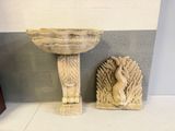 two statues of a bird and a bowl on a shelf