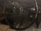 an old car with a steering wheel and a steering wheel on the dashboard