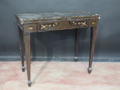 an old wooden table with a marble top on a carpeted floor