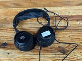 a pair of black headphones on a wooden table
