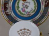 a close up of a cup and saucer sitting on a table