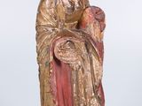 an old statue of a woman with a crown on her head