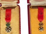 two medals in a red case with a red ribbon