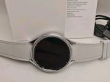 the samsung smart watch is sitting on top of a white box