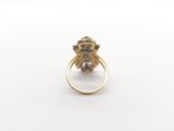a close up of a gold ring with a flower on it