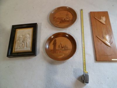 three wooden plates and a ruler on the floor