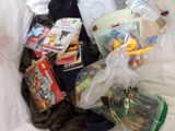 a bag full of toys and books on a bed