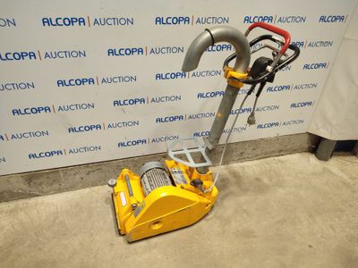 a close up of a machine on the ground near a wall