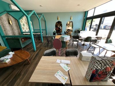 a room with a lot of tables and chairs in it