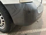 a close up of a car ' s bumper with a hole in it