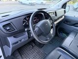 a dashboard and steering wheel of a vehicle in a parking lot