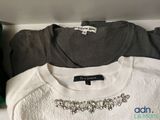 three t - shirts that are sitting on a shelf