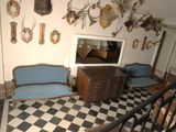a room with a checkered floor and a lot of antelope heads on the wall